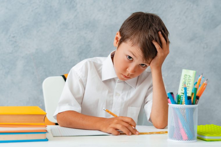 back school happy smiling student draws desk